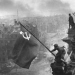 The Red Army raises the flag of the hammer and sickle over the Reichstag